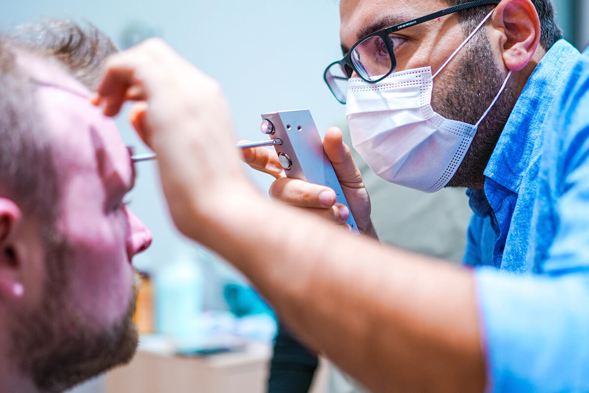 A practitioner performing hairline planning on a patient at Hermest Hair Clinic, Istanbul (official clinic photo).