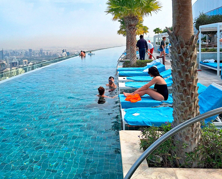 Address Beach Resort JBR rooftop infinity pool with palm trees and skyline view
