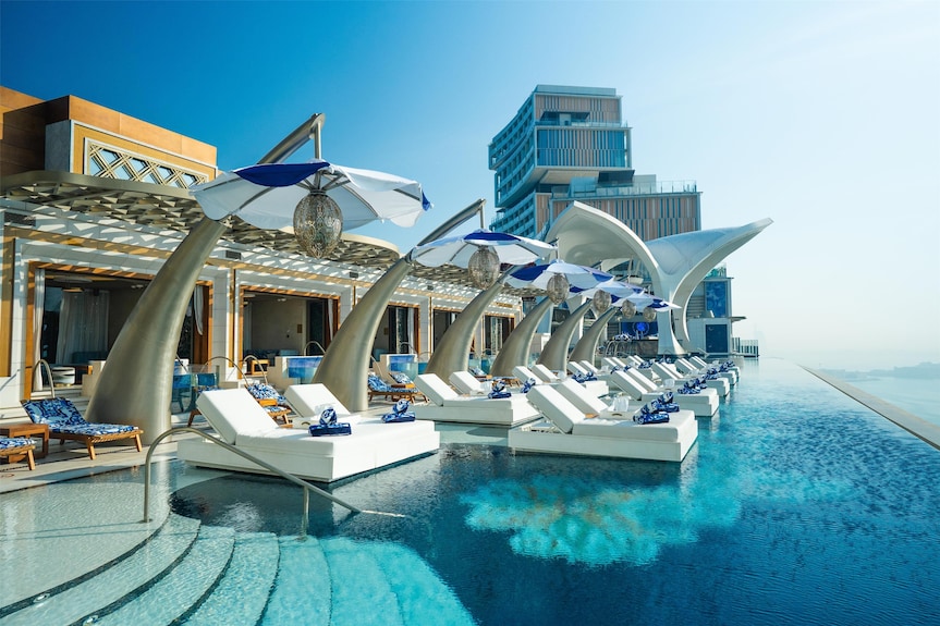 Atlantis The Royal infinity pool with cabanas and sculptural umbrellas
