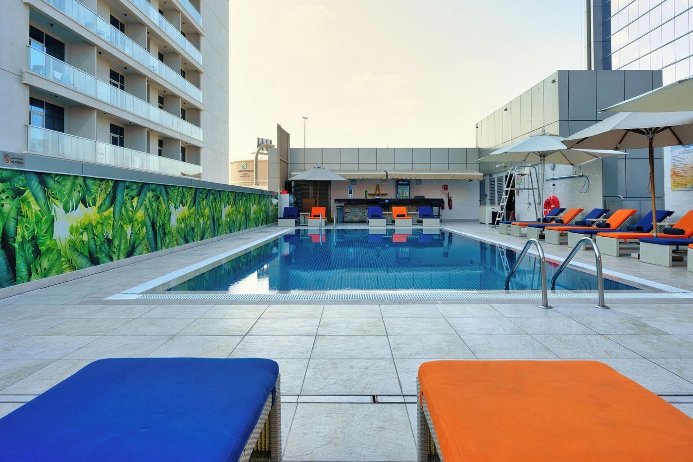 The First Collection Dubai Marina rooftop pool with tropical mural
