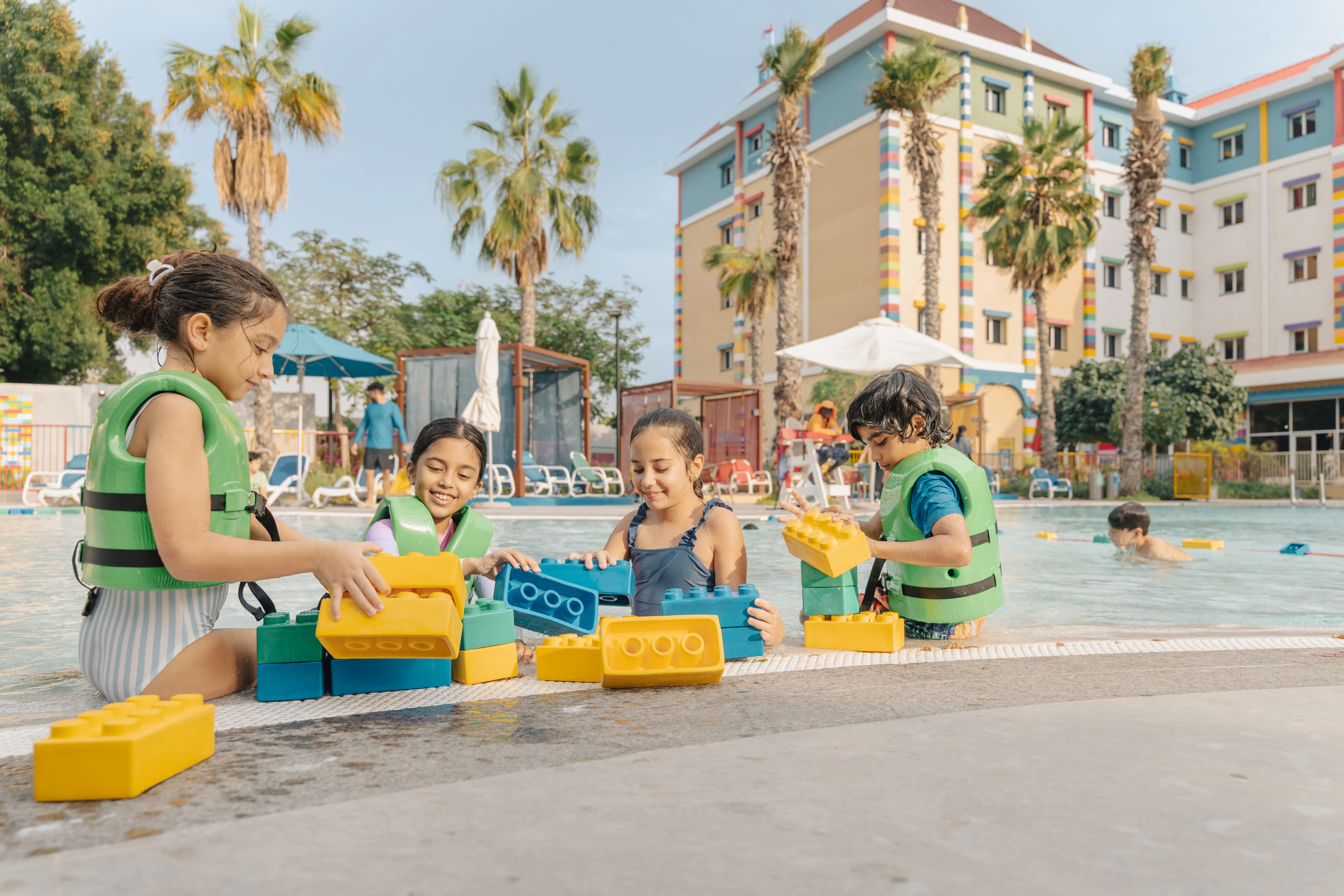 Children playing with giant LEGO blocks at LEGOLAND Hotel Dubai pool