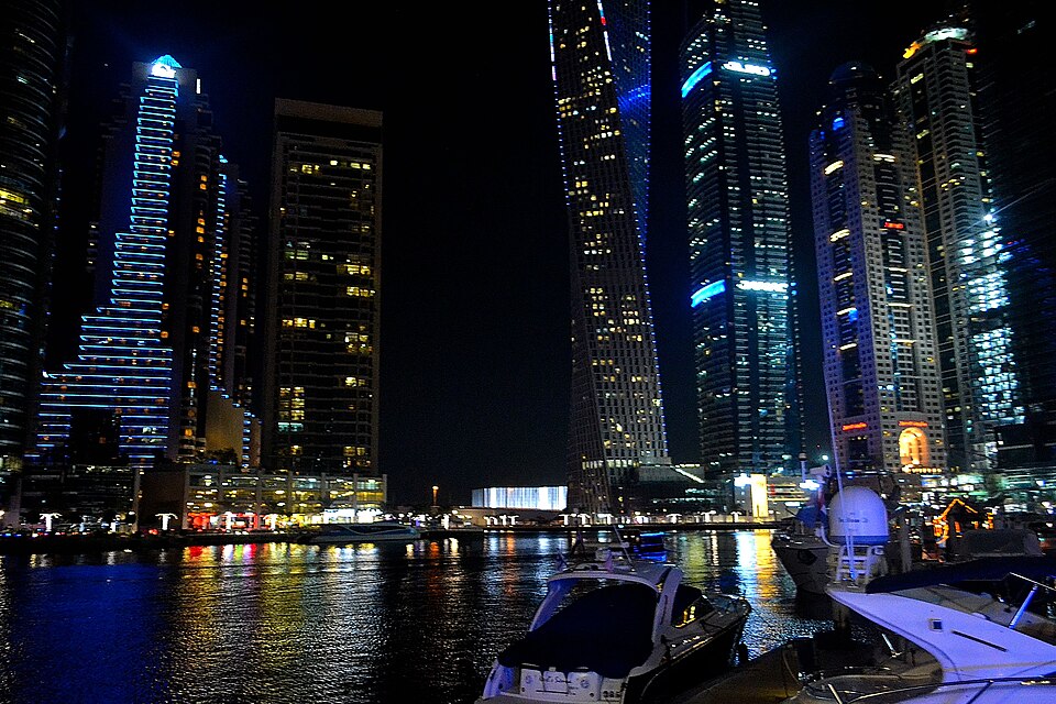 High-rise buildings and lights across Dubai Marina at night